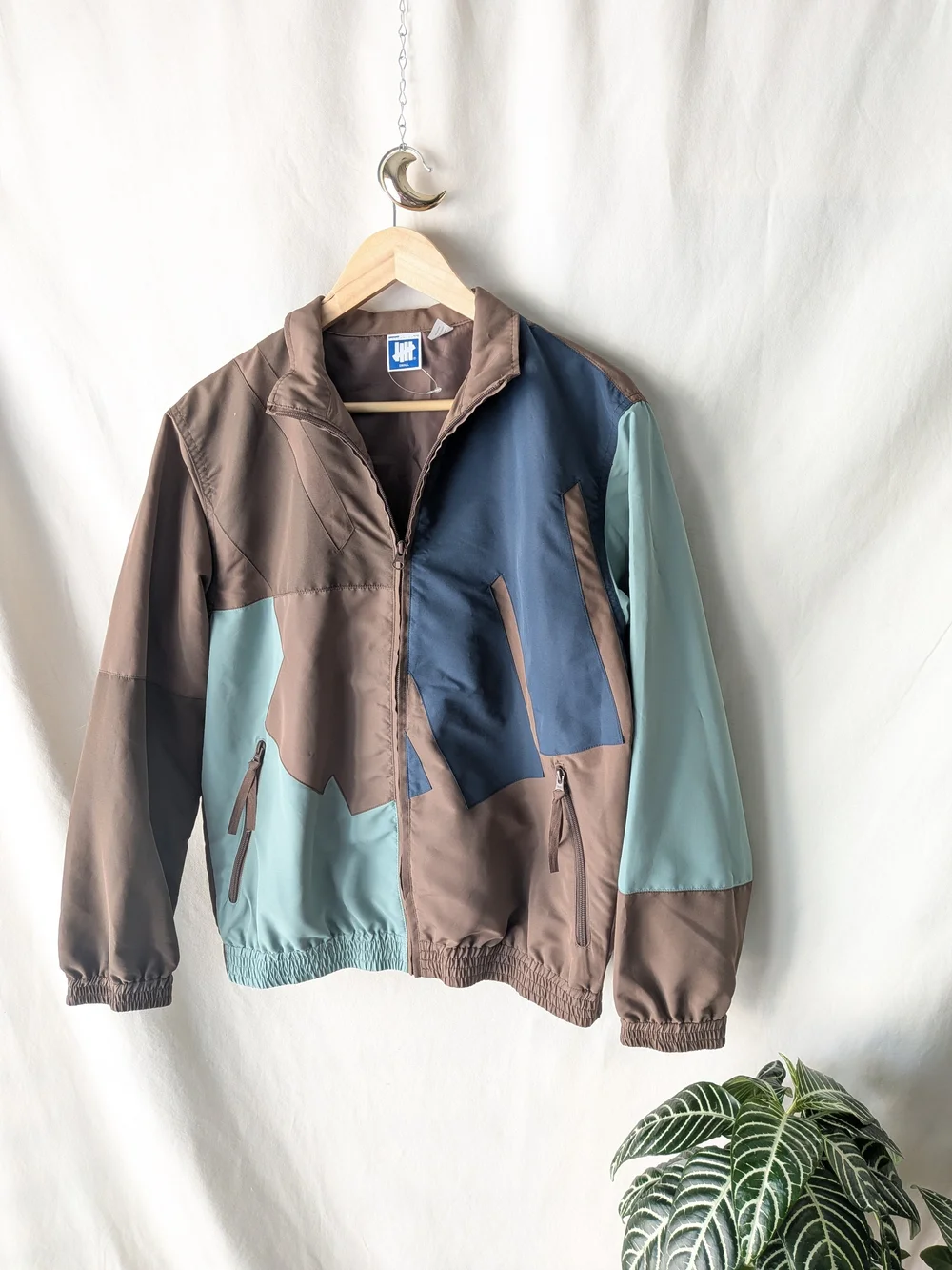 Undefeated Jacket in Taupe and Beige with Blue Logo Tag